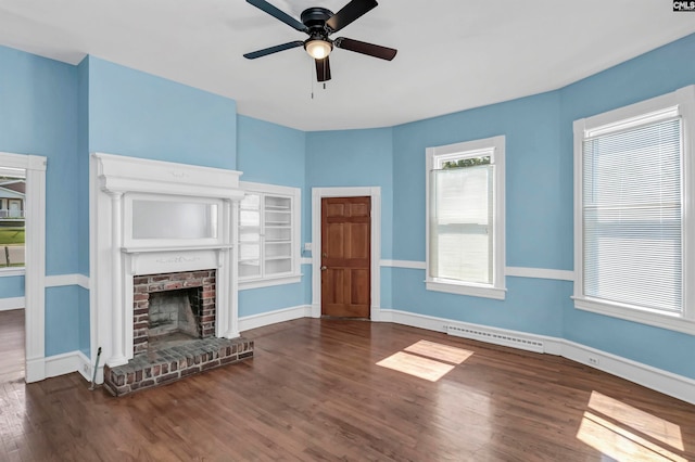 unfurnished living room with ceiling fan, a fireplace, and dark hardwood / wood-style flooring