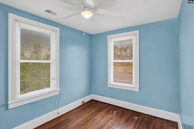 empty room with hardwood / wood-style floors and ceiling fan