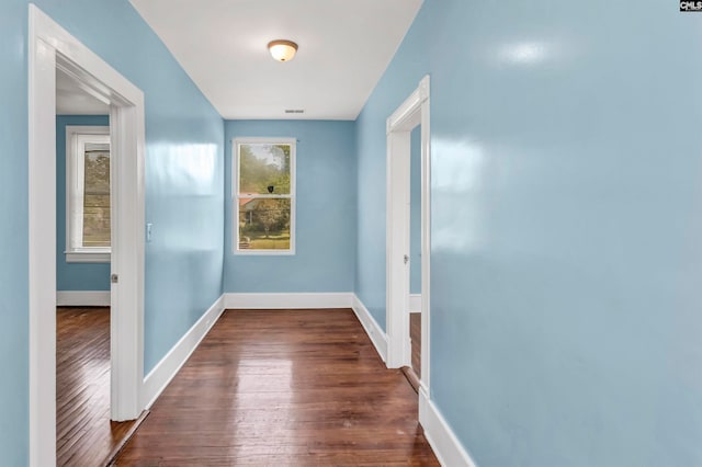 hallway featuring dark hardwood / wood-style flooring