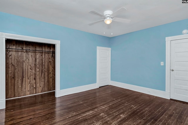 unfurnished bedroom featuring ceiling fan, a closet, and dark hardwood / wood-style floors