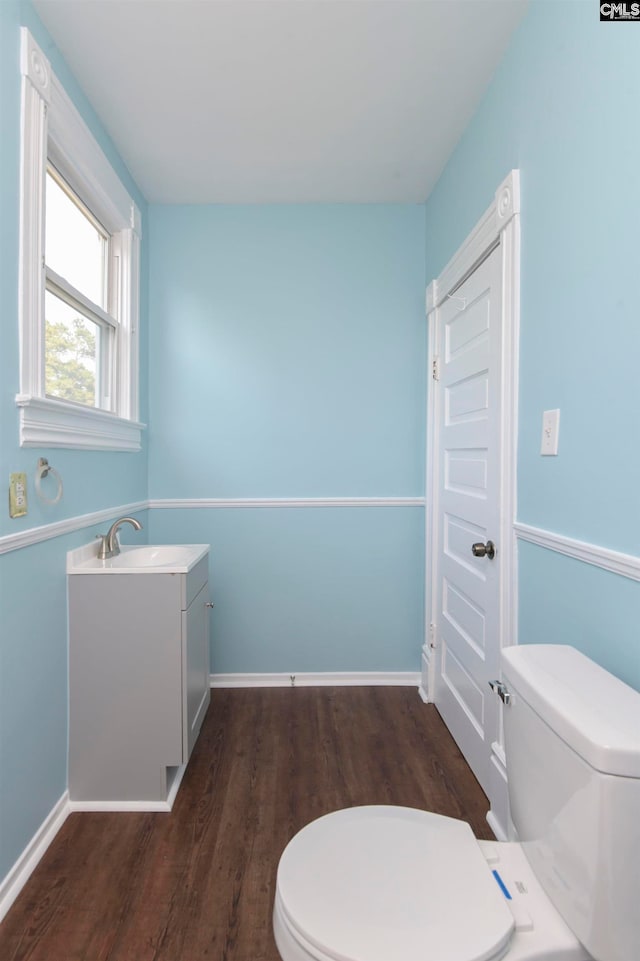 bathroom featuring wood-type flooring, vanity, and toilet