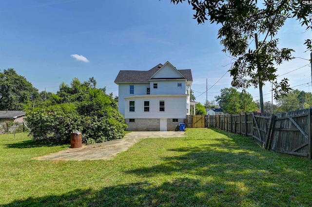 rear view of property featuring a patio and a yard