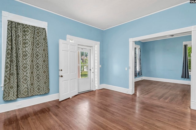 foyer with ornamental molding and hardwood / wood-style flooring