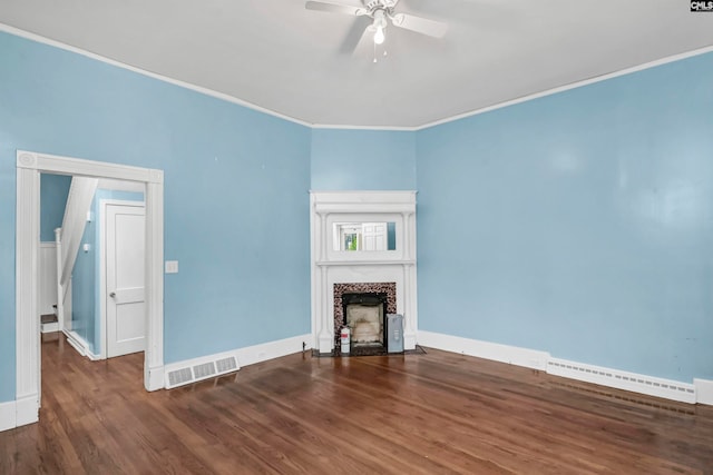 unfurnished living room featuring a baseboard radiator, ceiling fan, dark wood-type flooring, and crown molding