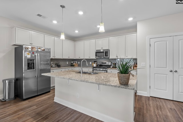 kitchen with appliances with stainless steel finishes, dark hardwood / wood-style flooring, sink, and white cabinets