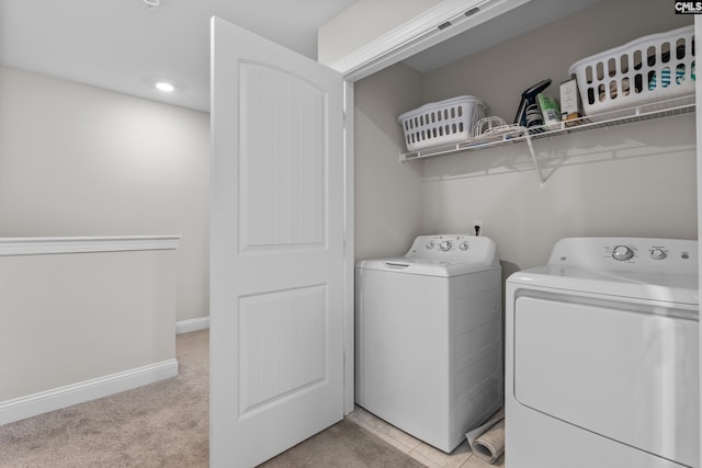 washroom featuring washing machine and clothes dryer and light colored carpet