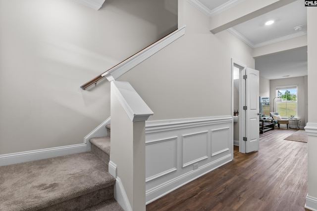 stairway featuring wood-type flooring and ornamental molding