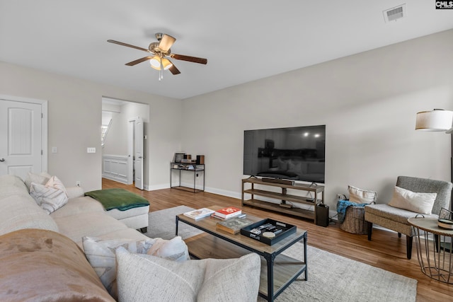 living room with ceiling fan and hardwood / wood-style flooring