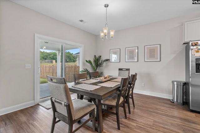 dining room featuring a chandelier and dark hardwood / wood-style flooring