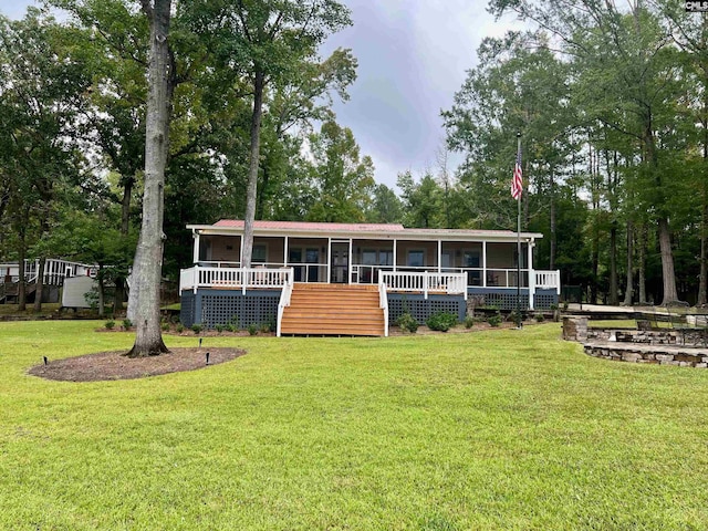 back of house with a wooden deck and a lawn