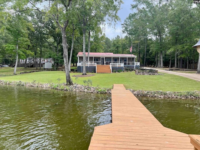 view of dock featuring a yard and a water view