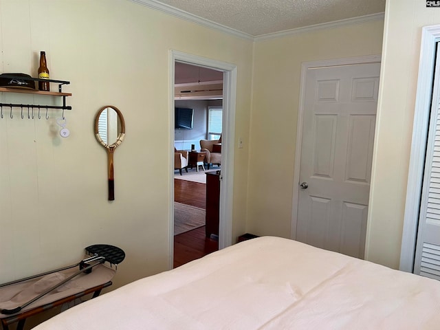 bedroom featuring a textured ceiling, a closet, and ornamental molding