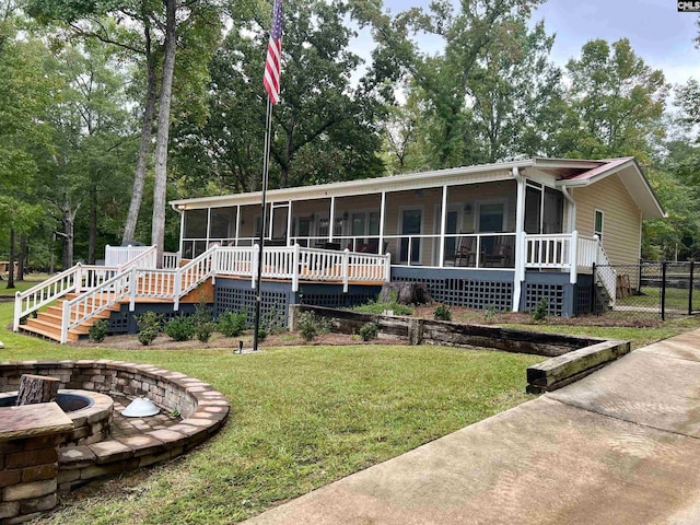 view of front facade featuring a front lawn and a sunroom