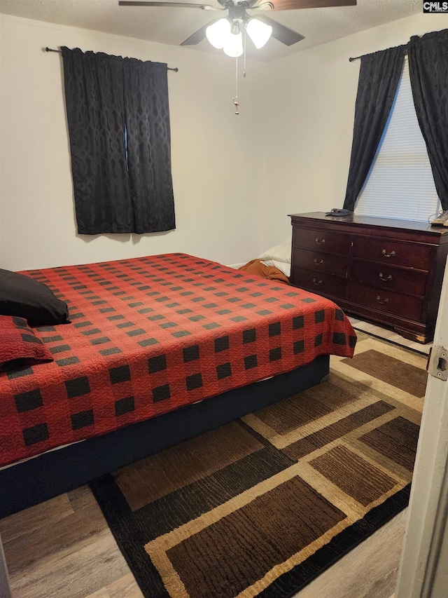 bedroom with hardwood / wood-style floors and ceiling fan