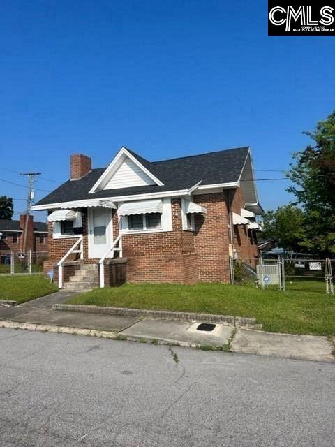 bungalow-style house featuring a front yard