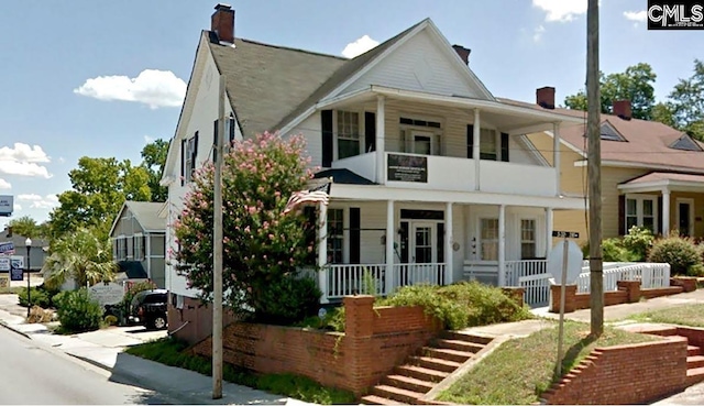 view of front of property with a balcony and covered porch