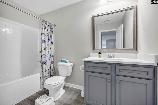 full bathroom with wood-type flooring, shower / bath combo, vanity, and toilet