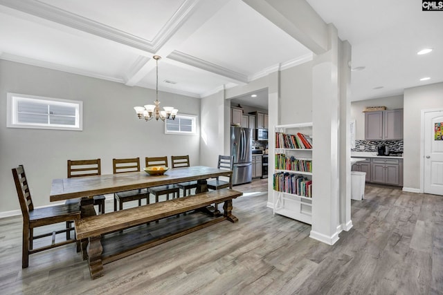 dining area featuring beamed ceiling, coffered ceiling, an inviting chandelier, light wood-type flooring, and crown molding