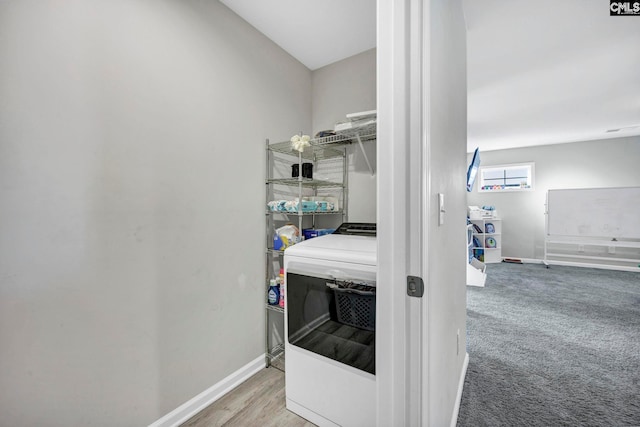 laundry area with light colored carpet