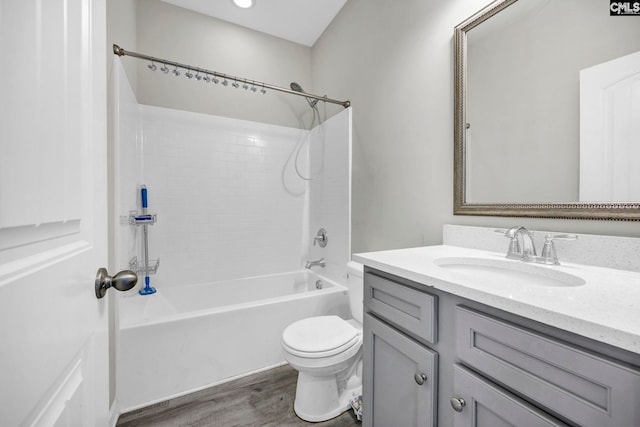 full bathroom with hardwood / wood-style floors, vanity, bathtub / shower combination, and toilet