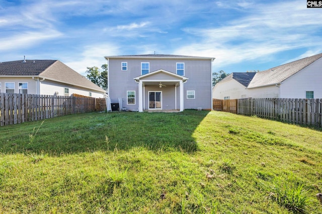 rear view of property featuring a yard