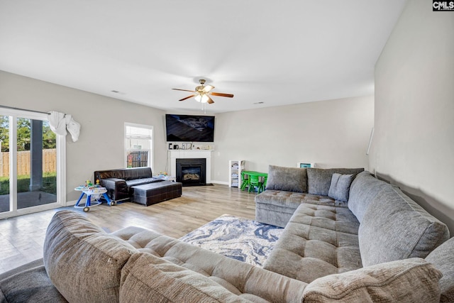 living room featuring ceiling fan and hardwood / wood-style flooring