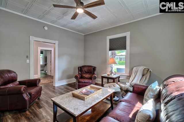 living room with ornamental molding, ceiling fan, and dark hardwood / wood-style flooring