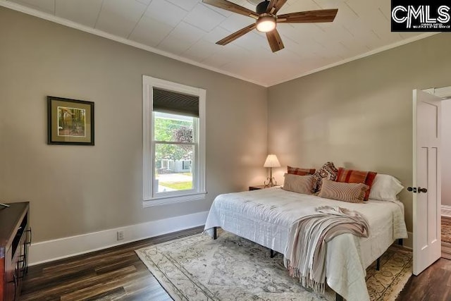 bedroom featuring ornamental molding, dark wood-type flooring, and ceiling fan