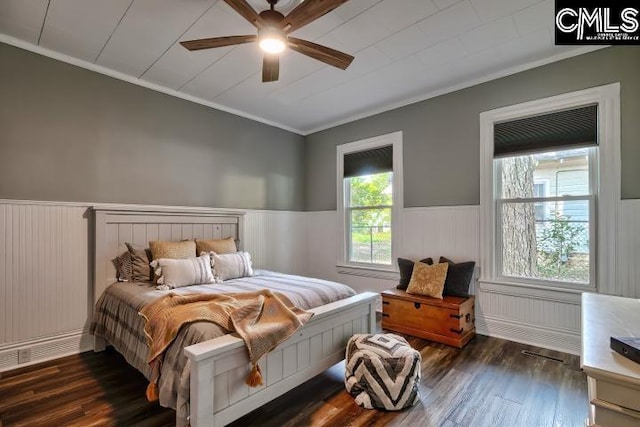 bedroom featuring ceiling fan, crown molding, and dark hardwood / wood-style flooring