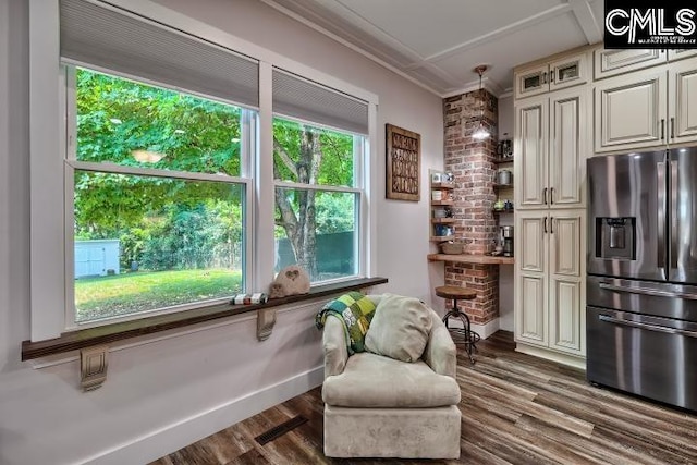 living area with brick wall, dark hardwood / wood-style floors, and crown molding