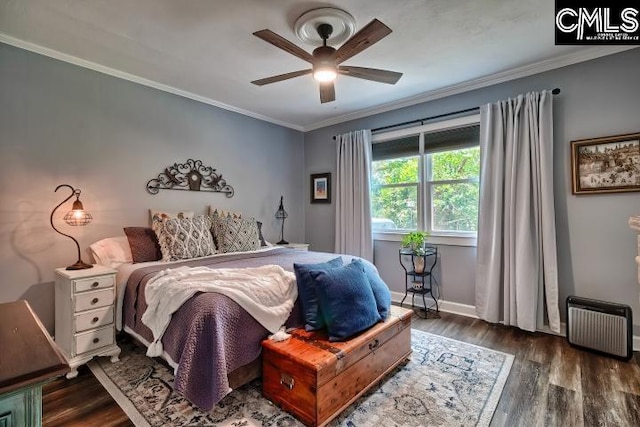 bedroom with ceiling fan, ornamental molding, dark wood-type flooring, and radiator heating unit