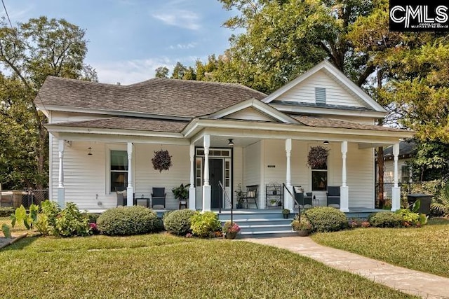 bungalow-style house featuring covered porch and a front yard