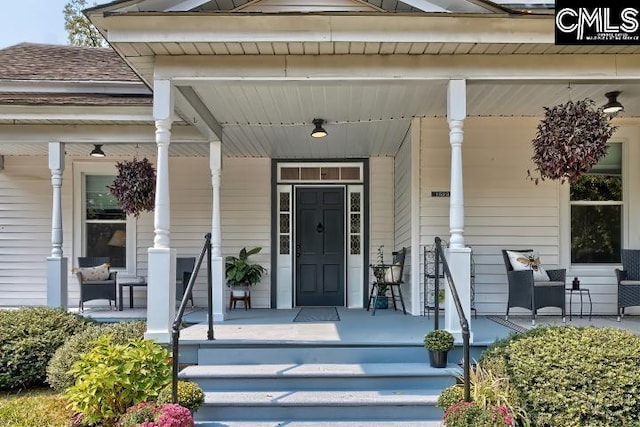 view of exterior entry with covered porch