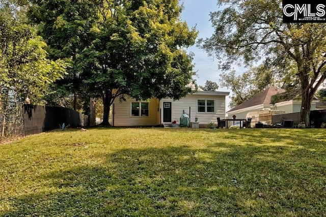 rear view of property with a lawn