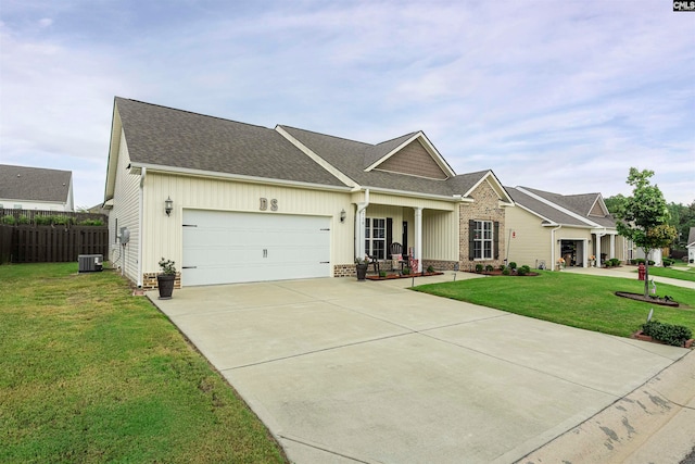 view of front of house featuring central AC, a front lawn, and a garage