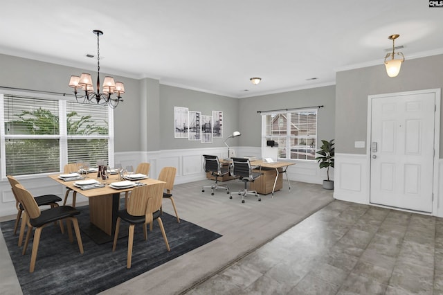 dining area featuring crown molding and a chandelier