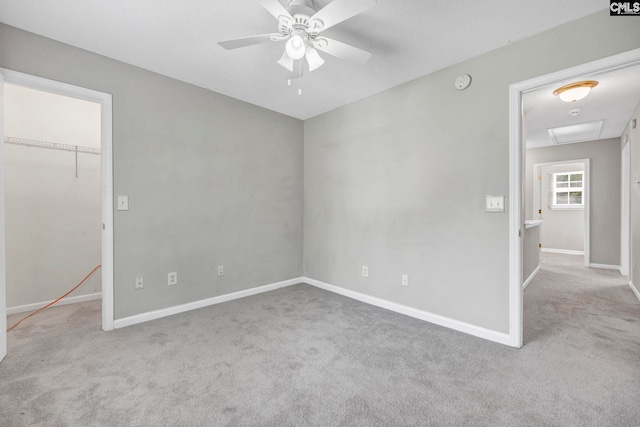 spare room with light carpet and ceiling fan