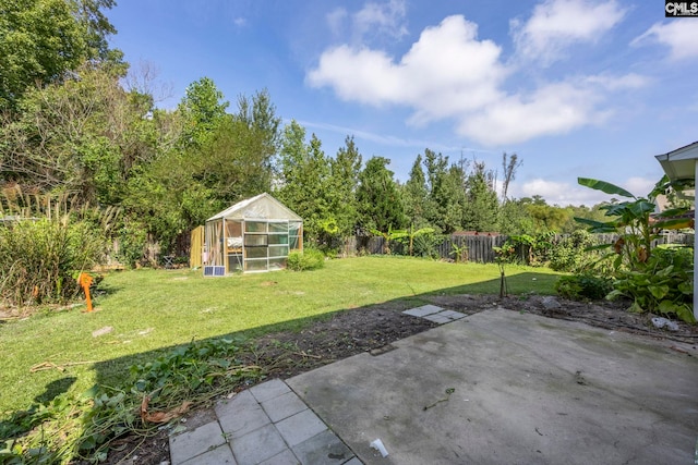 view of yard with an outdoor structure and a patio