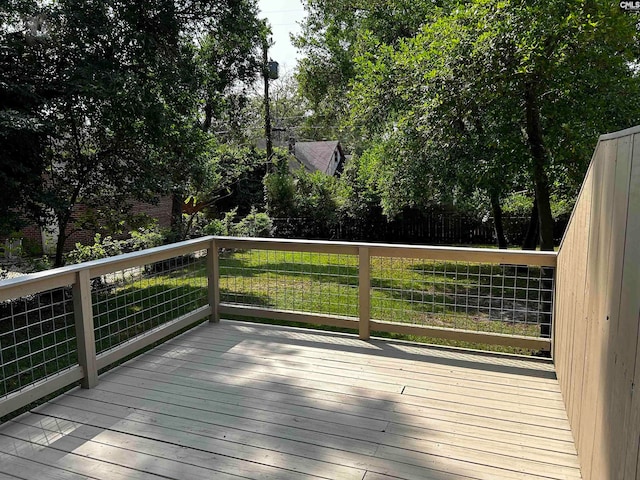 wooden deck featuring a yard