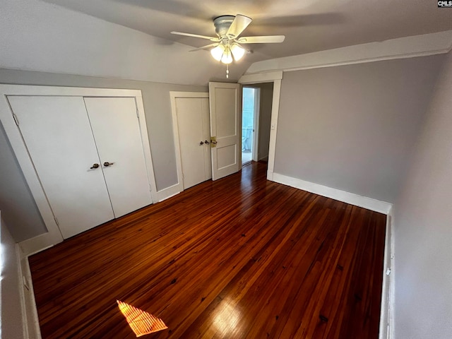 unfurnished bedroom with ceiling fan and dark wood-type flooring