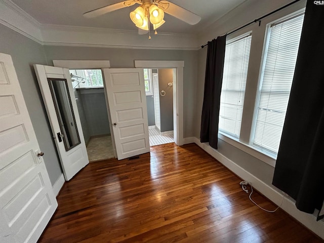 unfurnished bedroom featuring ornamental molding, ceiling fan, and dark hardwood / wood-style floors