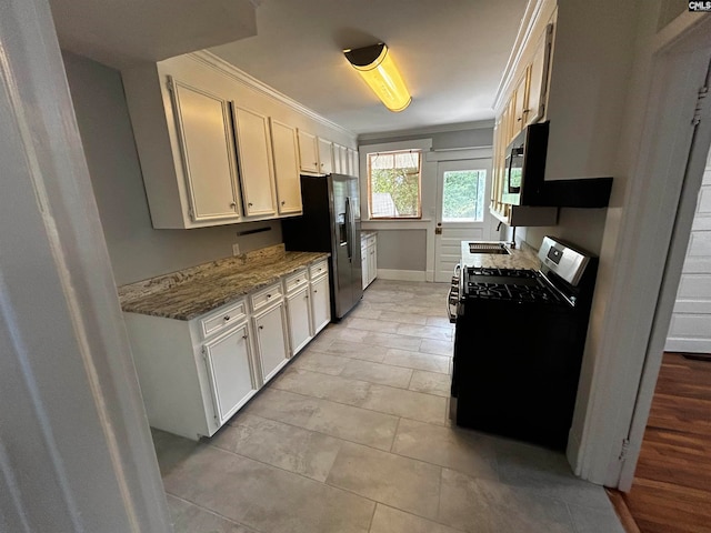 kitchen with light stone counters, white cabinets, stainless steel appliances, and ornamental molding