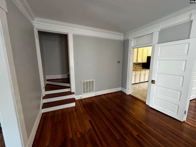 unfurnished room with ornamental molding and dark hardwood / wood-style floors