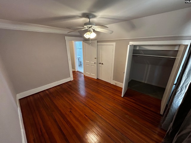 unfurnished bedroom featuring crown molding, dark hardwood / wood-style floors, and ceiling fan