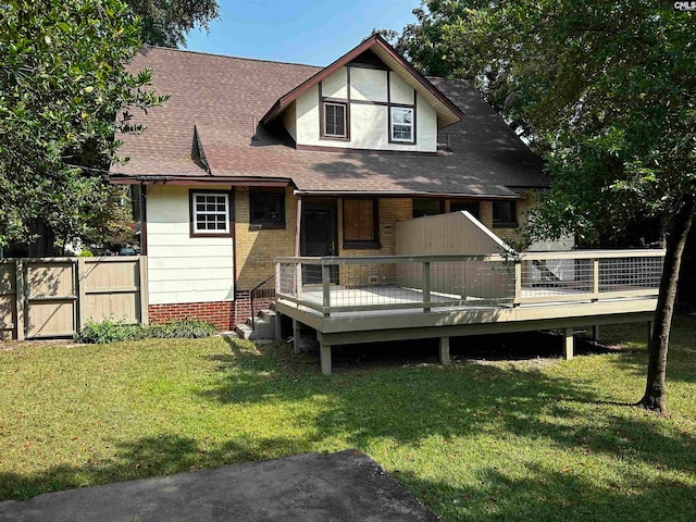 back of property featuring a deck and a yard