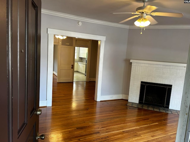 unfurnished living room featuring crown molding, a fireplace, dark hardwood / wood-style flooring, and ceiling fan