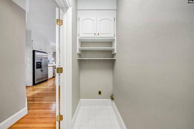 laundry area with light hardwood / wood-style floors and electric dryer hookup