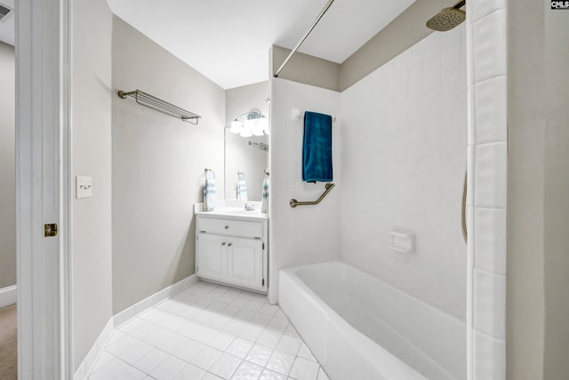 bathroom featuring tiled shower / bath, vanity, and tile patterned flooring