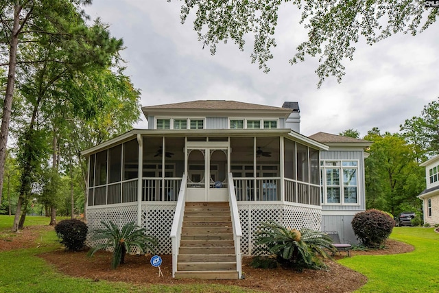 exterior space with a sunroom and a front yard