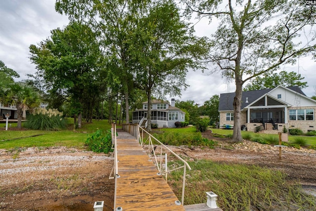 back of house featuring a sunroom and a yard